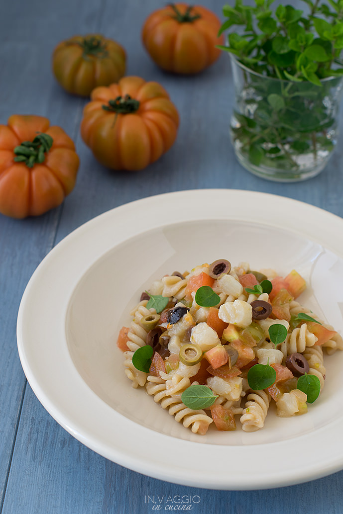 Pasta salad with tomatoes, olives and white fish
